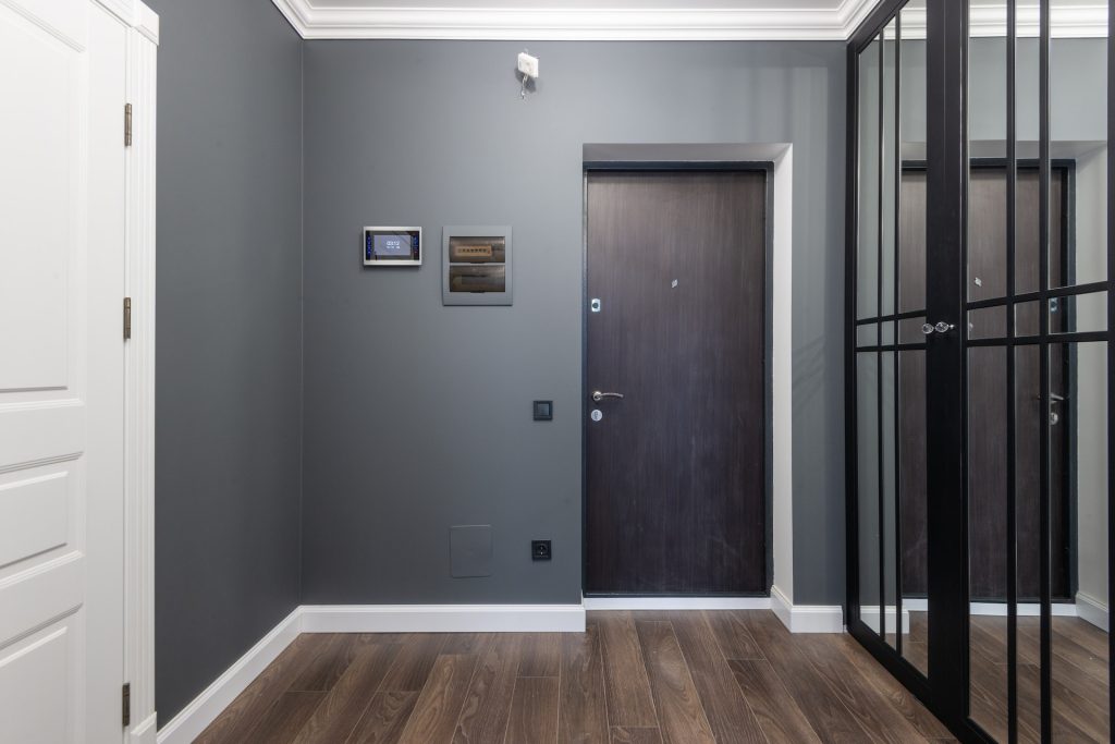 Spacious corridor of modern apartment with mirrored wardrobe